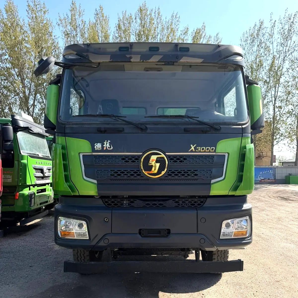 Green SHACMAN X3000 8x4 dump truck front view with gold logo