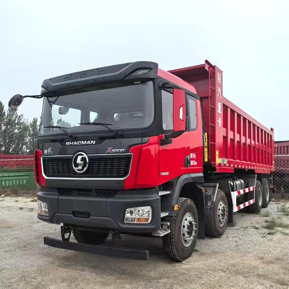 Red SHACMAN X5000 8x4 dump truck front view with 490 horsepower engine