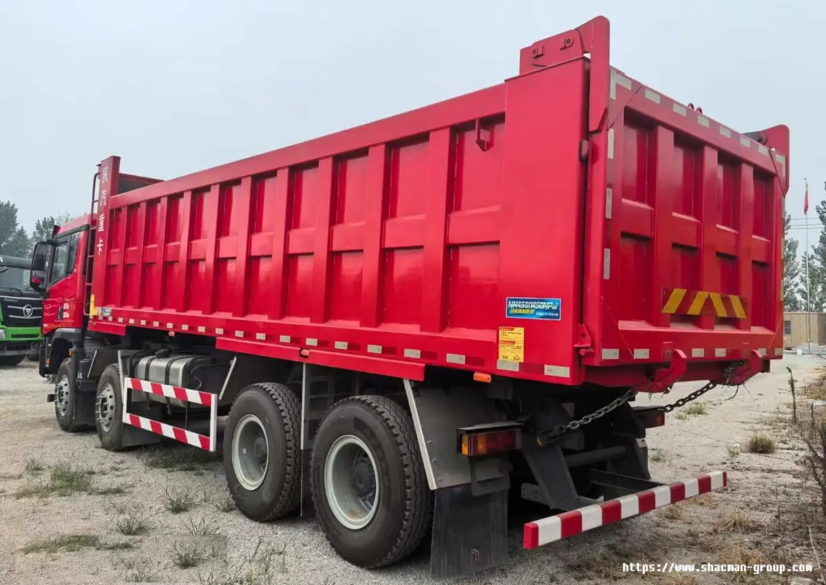 Red SHACMAN X5000 8x4 dump truck side view with large capacity dump body