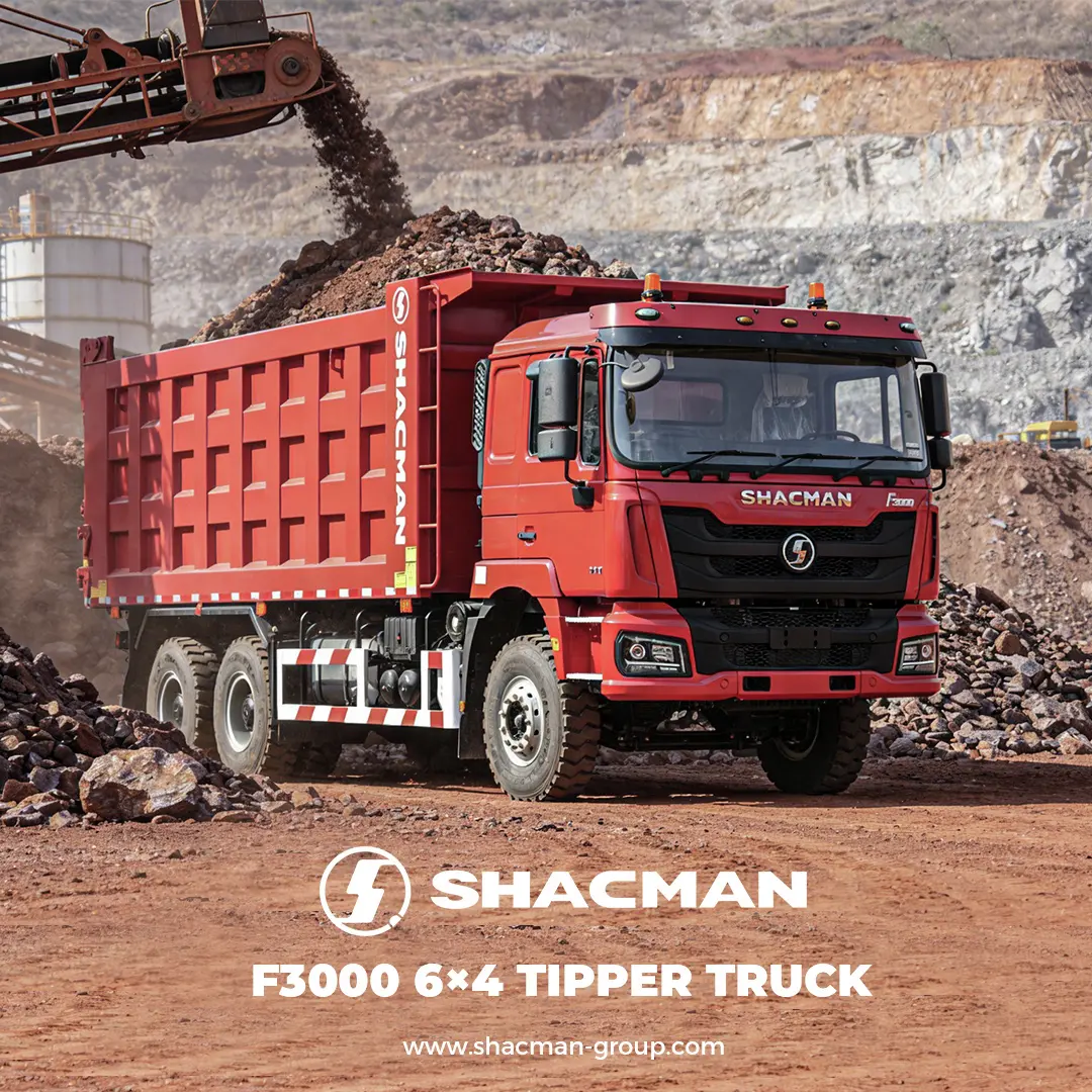 Red SHACMAN F3000 6x4 tipper truck being loaded with ore at a mining site.