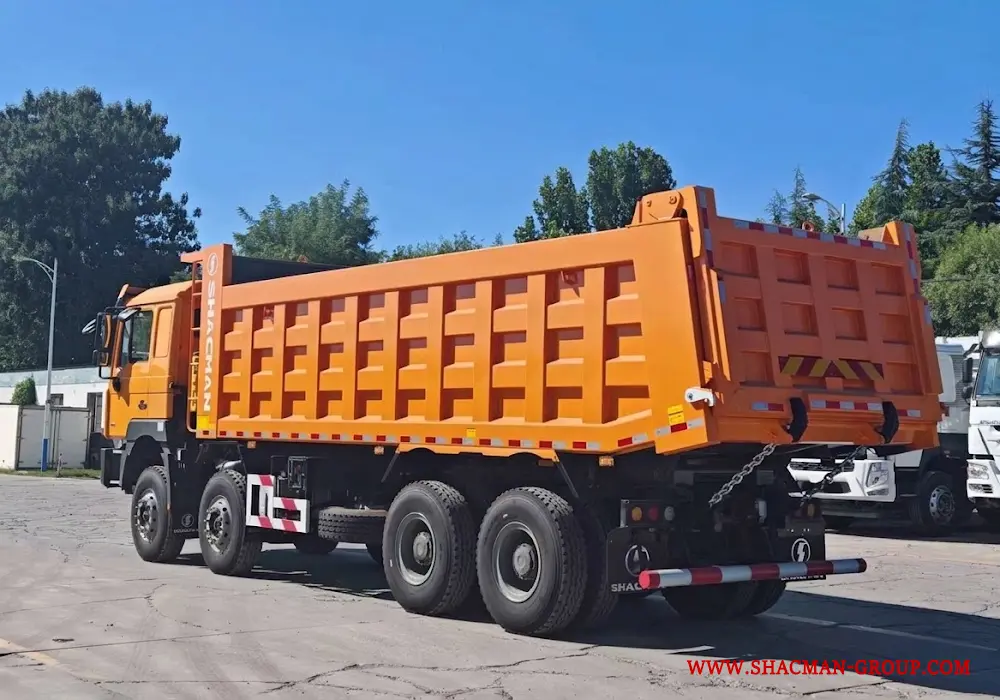 Yellow Shacman F3000 8x4 dump truck for sale in China, parked at an export yard.