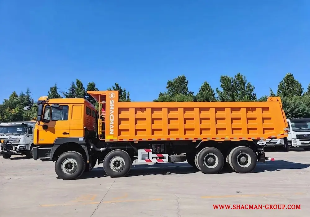 Yellow Shacman F3000 8x4 dump truck for sale in China, parked at an export yard.