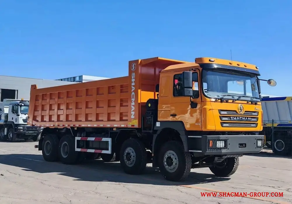 Yellow Shacman F3000 8x4 dump truck for sale in China, parked at an export yard.